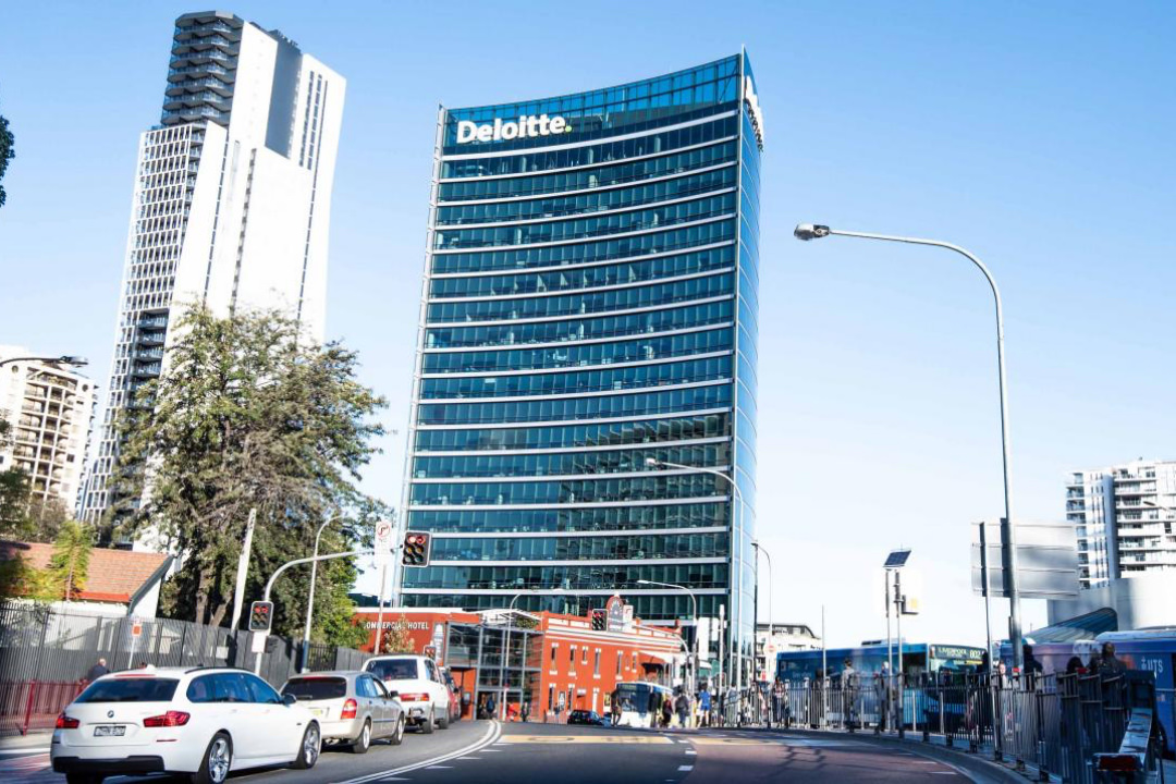 Image of professional services firm Deloitte taken from the top of Smith Street looking east. Illustrated are a number of residential and commercial buildings with the curved and mirrored front of the Deloitte Building as the centerpiece. 