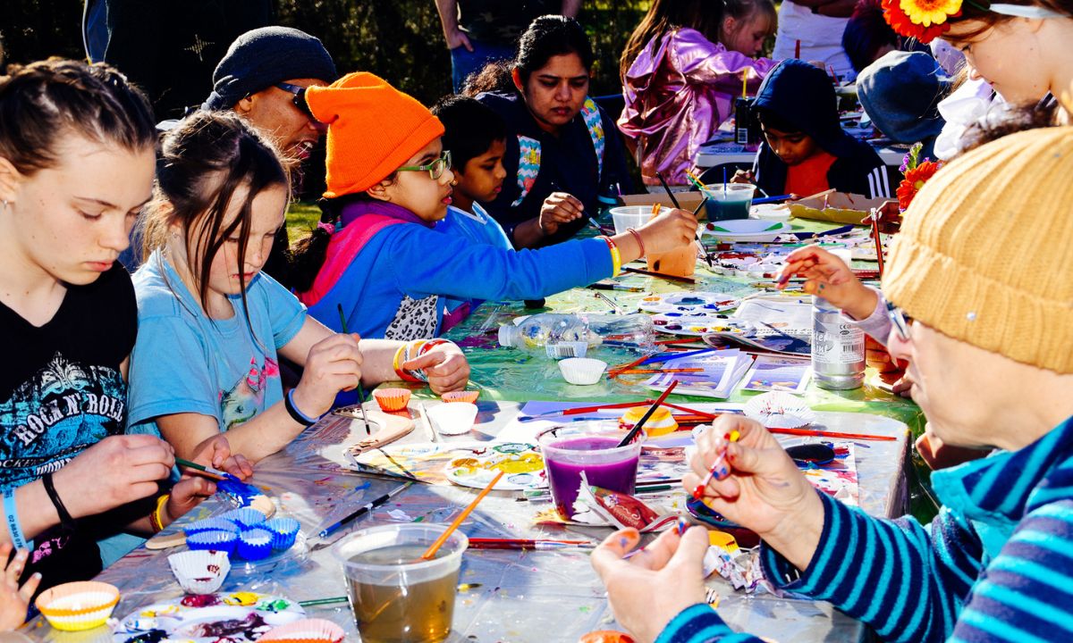 kids doing painting at an arts and crafts table