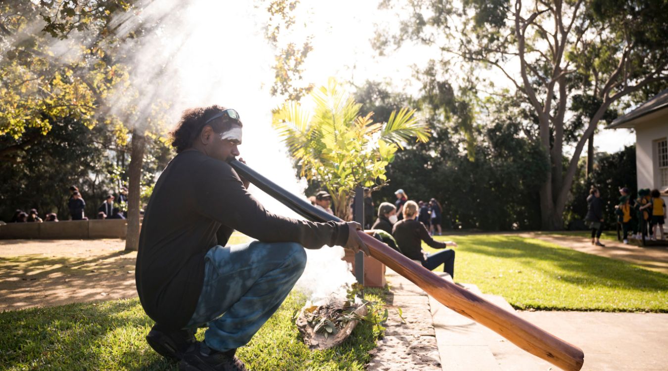First Nations man playing Didgeridoo 