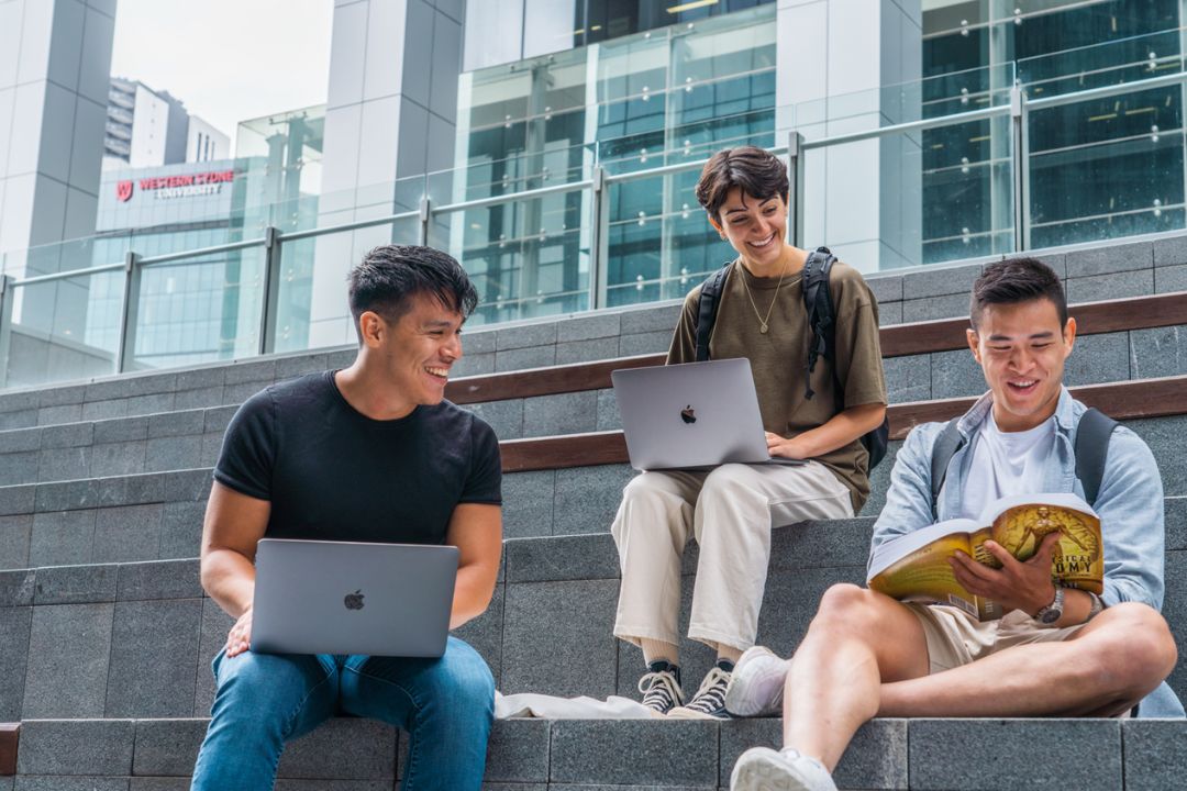 Young adults sitting on steps at Parramatta Square