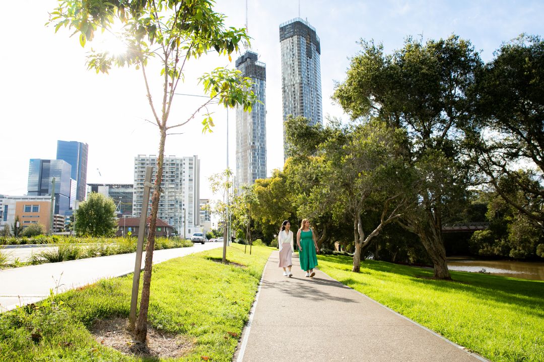 Two women walking on the banks of Parramatta River