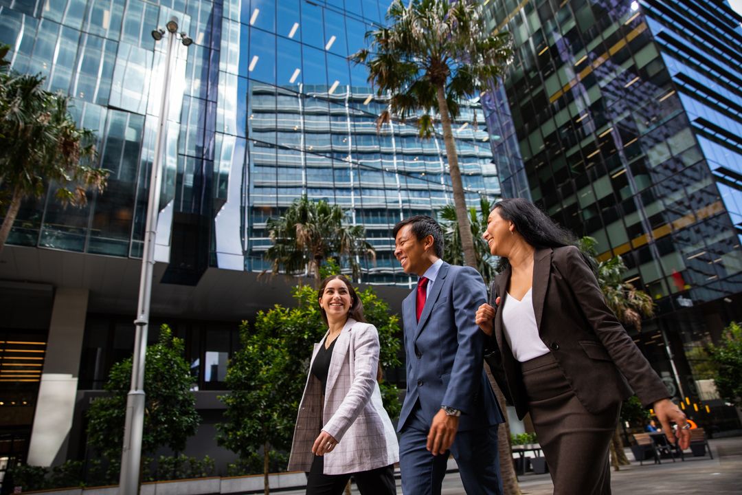 Three workers walking through Parramatta Square