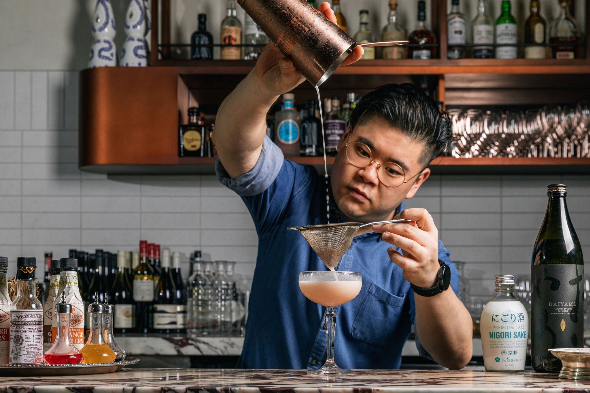 Bartender pouring a cocktail