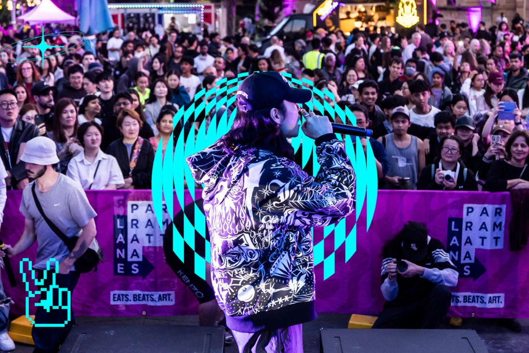 Man rapping on stage in front of an audience