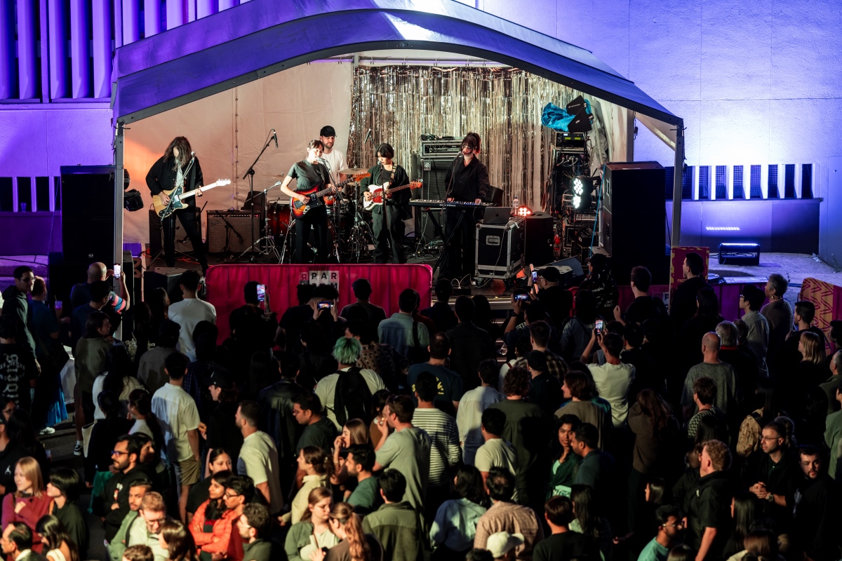 band playing on a stage in front of a big audience