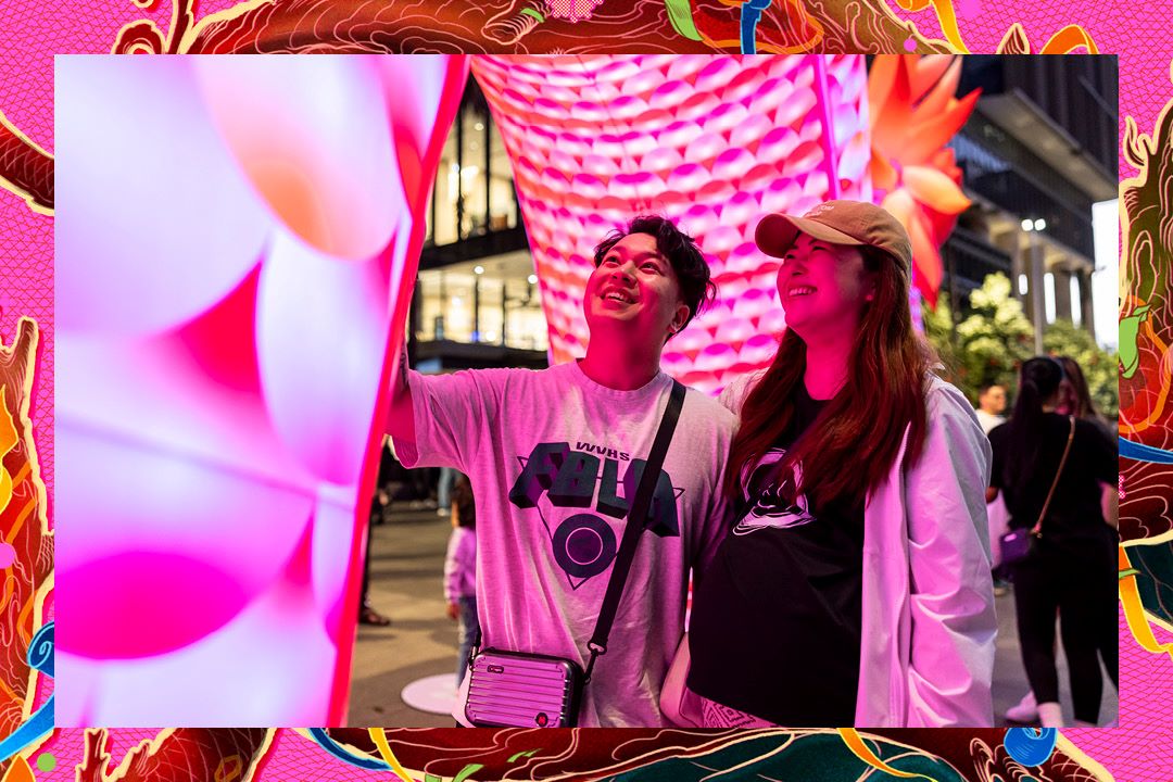 Two people glowing pink in shadow of inflatable