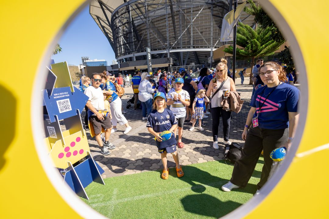 kids outside a stadium with a football