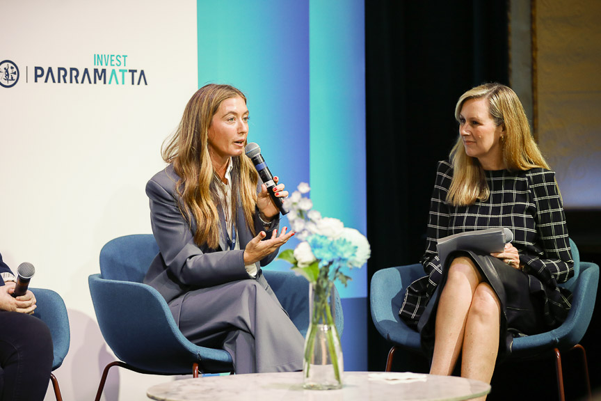 Two women speaking on stage