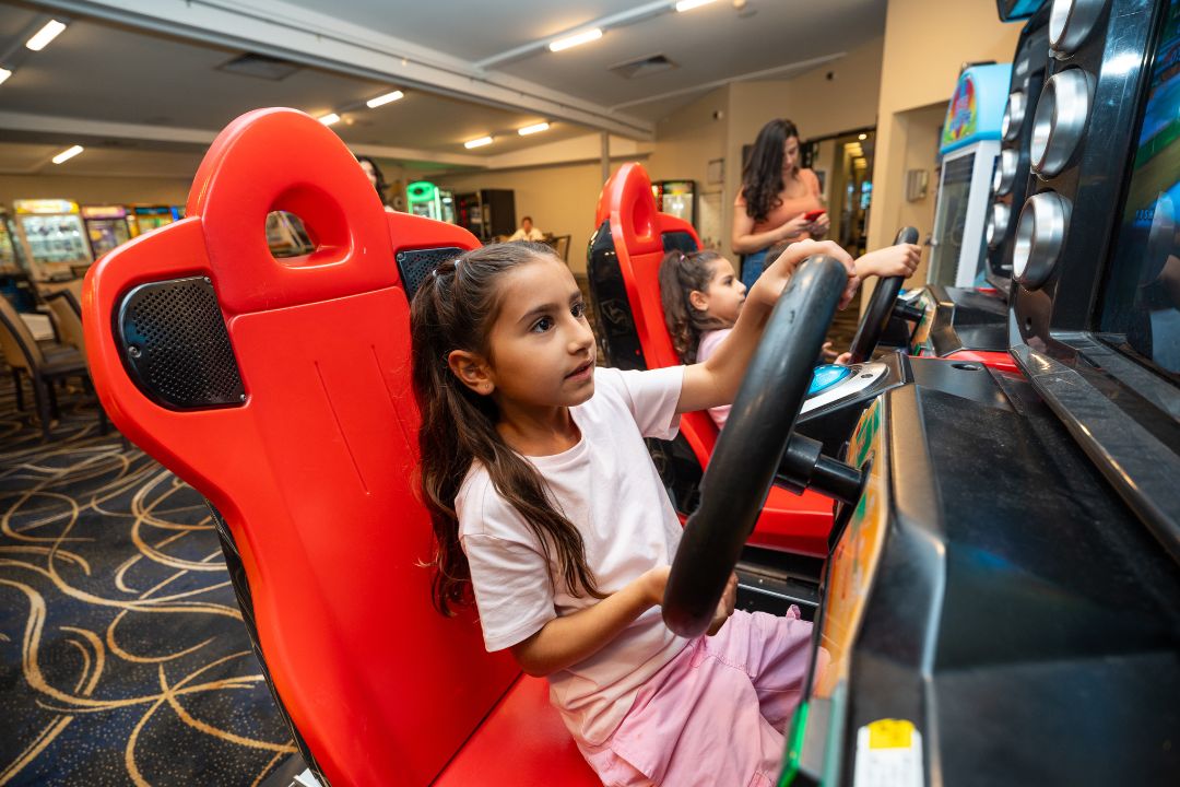 Girl driving an arcade car