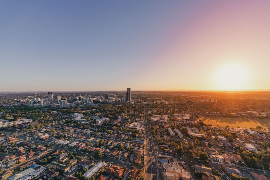 Aerial shot of a city landscape with the sunsetting