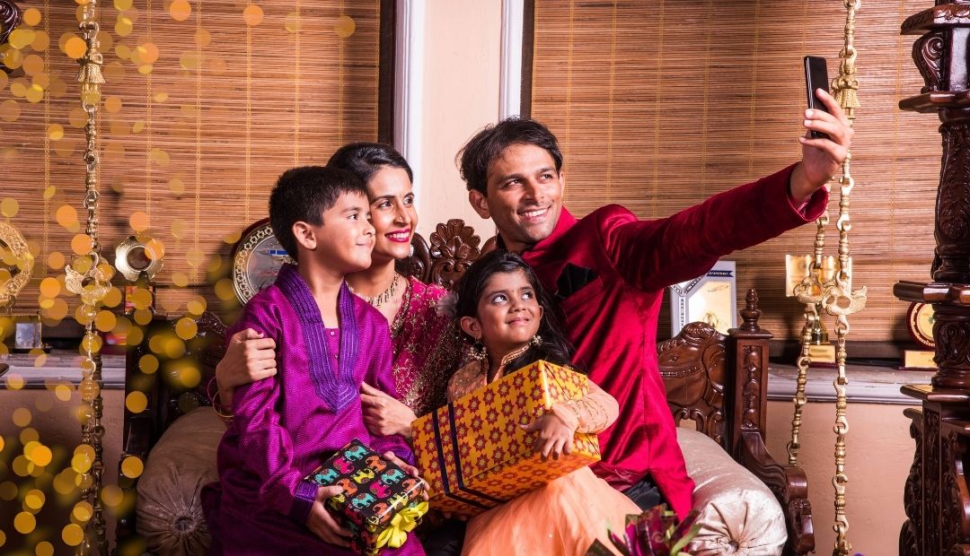 Indian family smiling at the camera taking a selfie