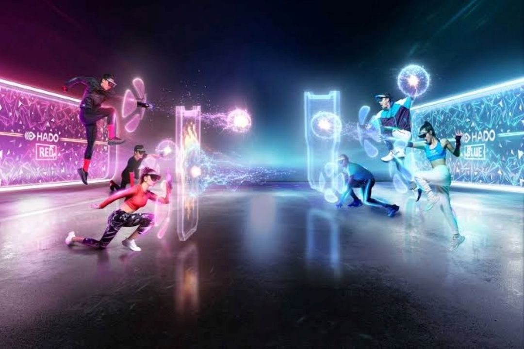 Futuristic holographic scene with stylized dancers in dynamic poses, surrounded by pink and blue neon lights. Energetic and vibrant atmosphere.