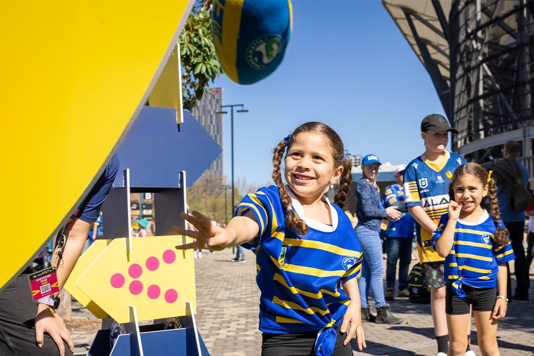 little girl in Eels shirt smiling