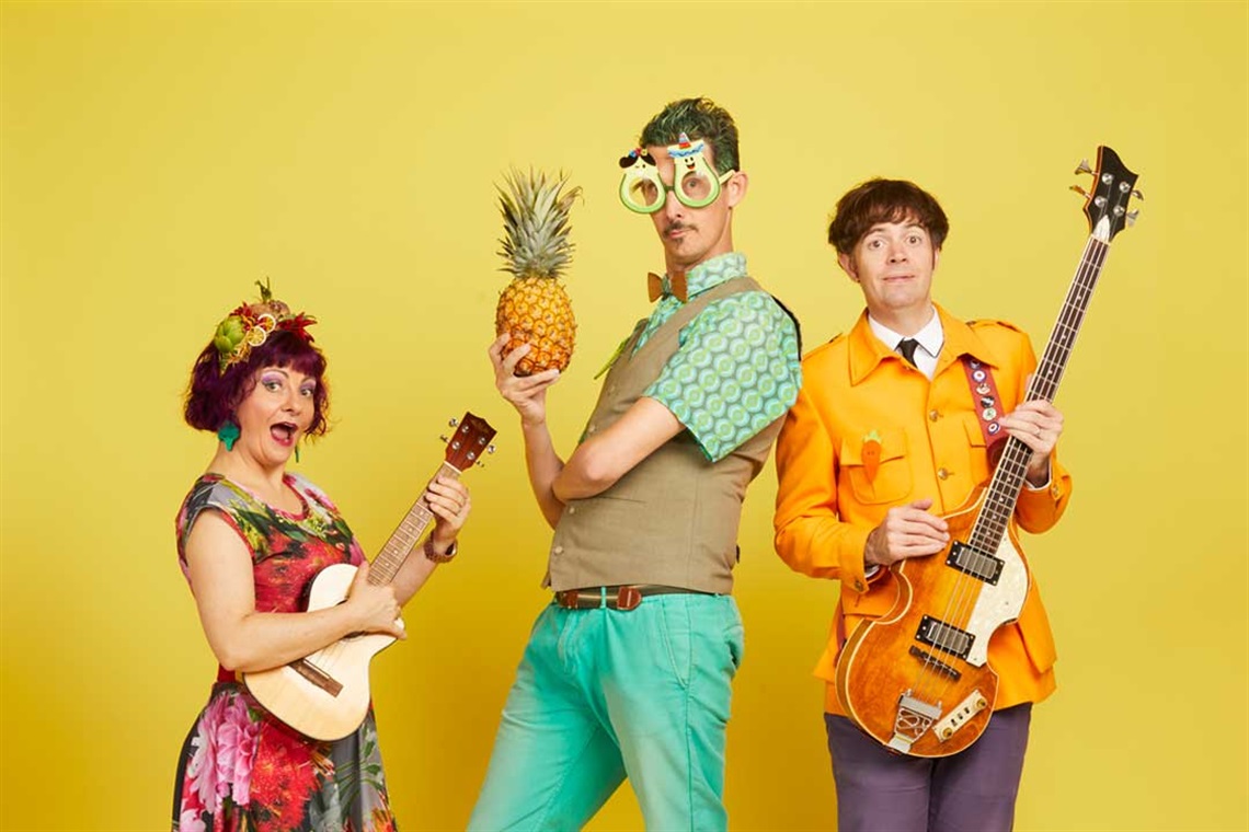 Three whimsical musicians against a yellow background. Each holds an instrument and wears colorful, quirky outfits, exuding a playful and joyful energy.