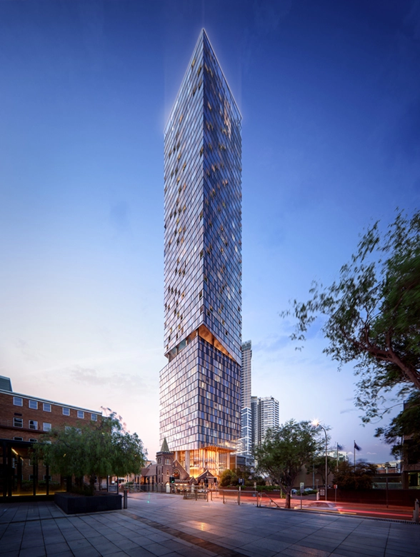 Tall, modern skyscraper with reflective glass facade set against a twilight sky.