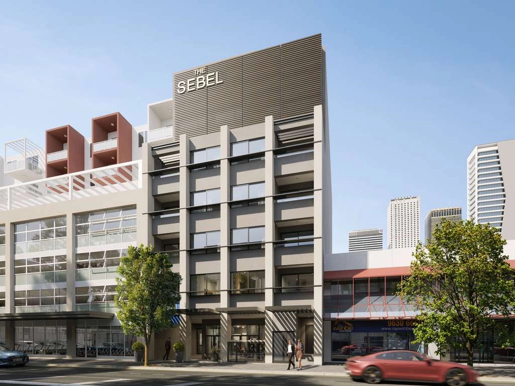 Street view of a modern hotel building named "The Sebel," featuring a sleek, gray facade.