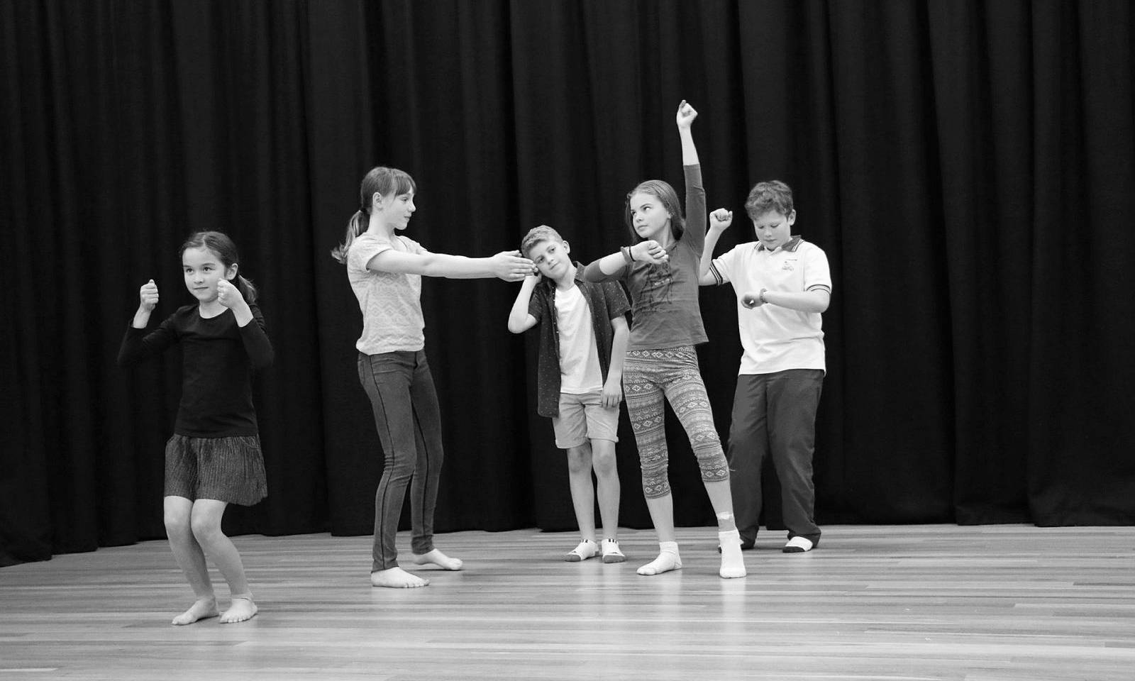 Kids performing on a stage together