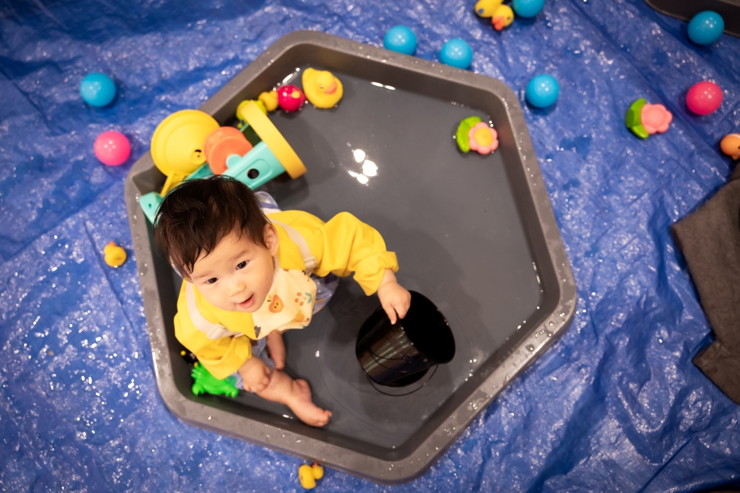 Little boy sitting in grey hexagon