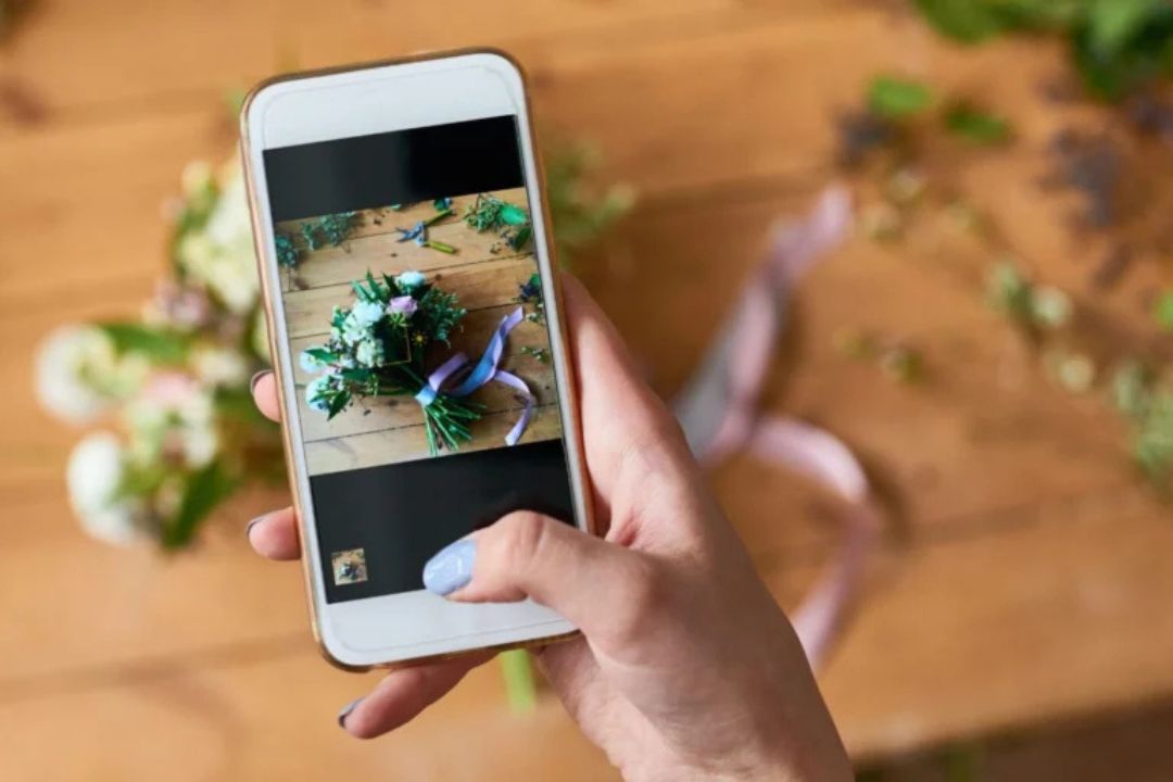 Phone taking a photo of flowers
