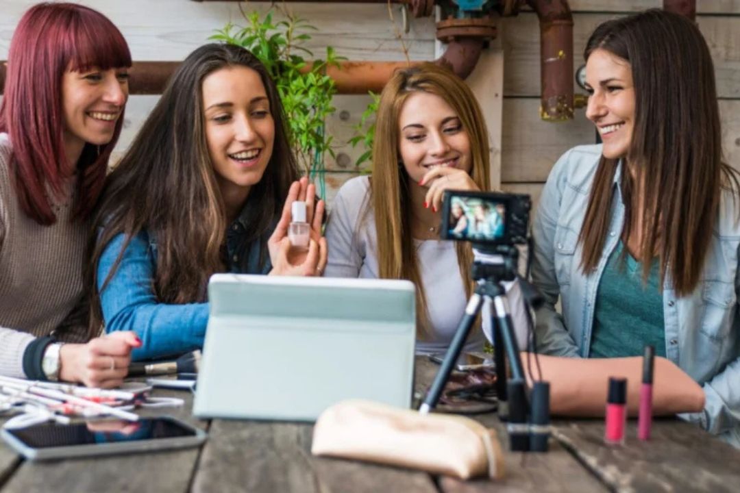 4 women smiling and looking at camera