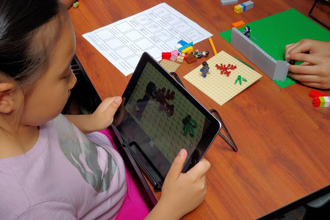 Girl on ipad creating LEGO animation
