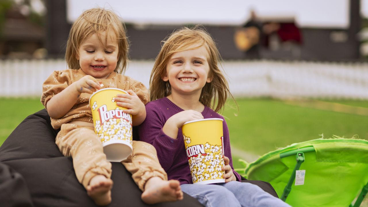 Children eating popcorn on beanbag