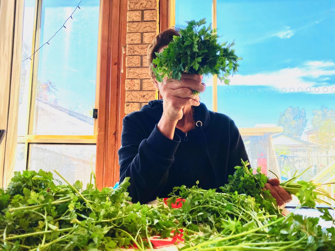 Woman with herbs covering her face