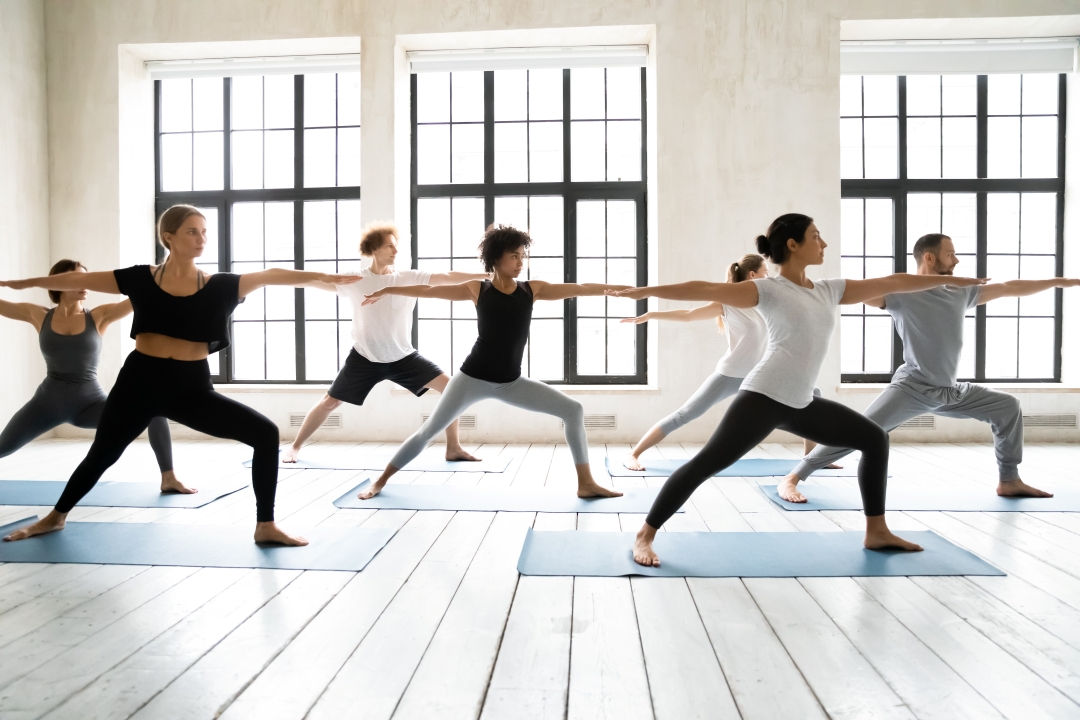 Men and women doing yoga on yoga mats