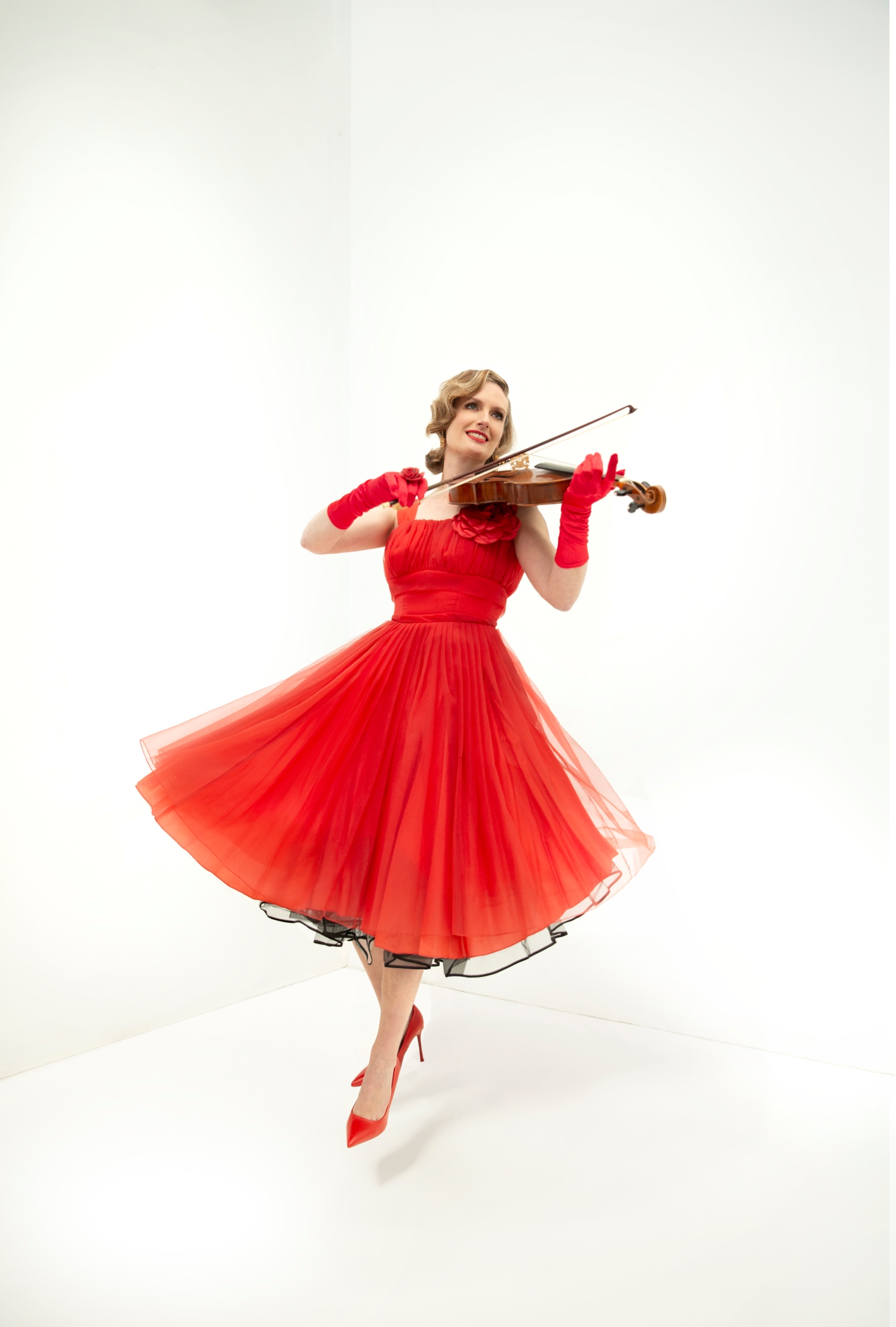 Woman wearing a red dress and playing a violin