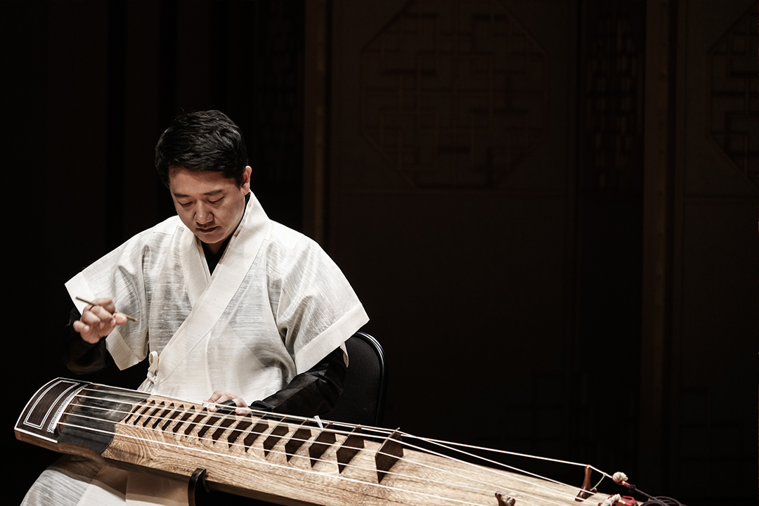 Man playing traditional Korean instrument