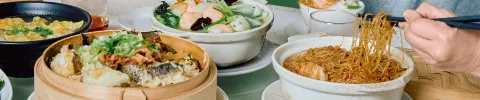Table full of food including noodles and dumplings