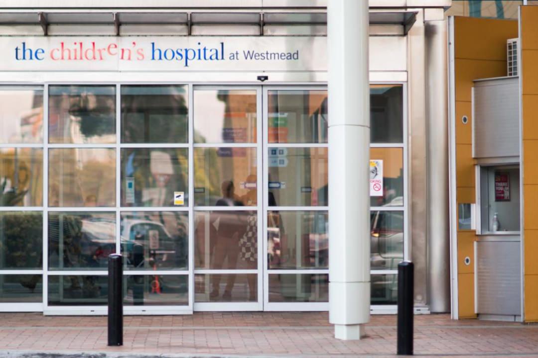 Image of the entrance to Westmead Childrens Hospital. The colourful logo baring the same name is at the top of the entryway