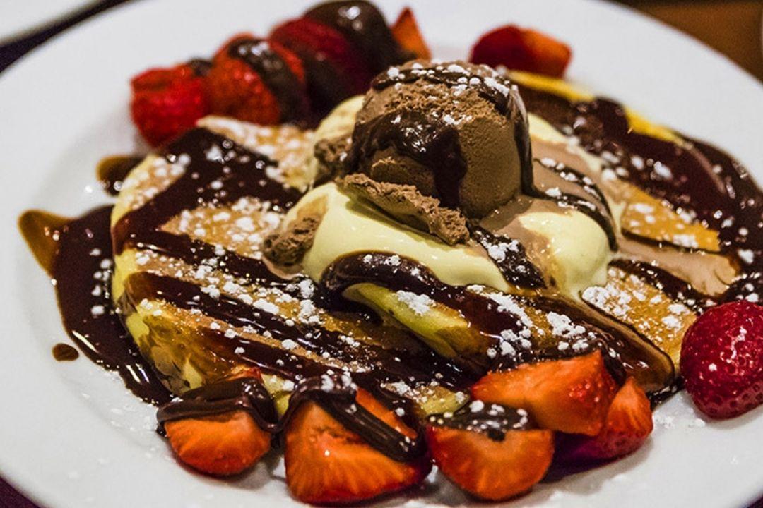 Pancakes with chocolate sauce and strawberries