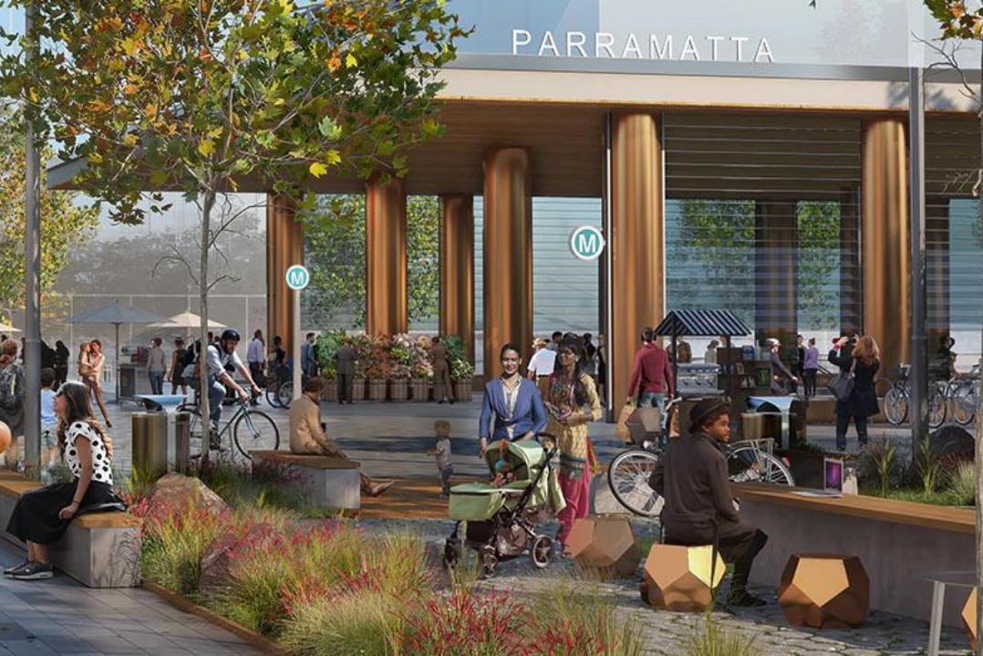ARCHITECTURAL RENDERING OF A NEW SYDNEY METRO WEST EXPRESS TRAIN STATION IN PARRAMATTA. THE MODERN OPEN CONCEPT ENTRY INTO THE STATION IS LINED WITH LEISURE AND WAITING SPACES FOR PASSENGERS AND THOSE WAITING FOR GUESTS. 