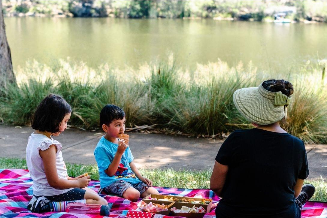 family enjoying a picnic at Lake Parramatta