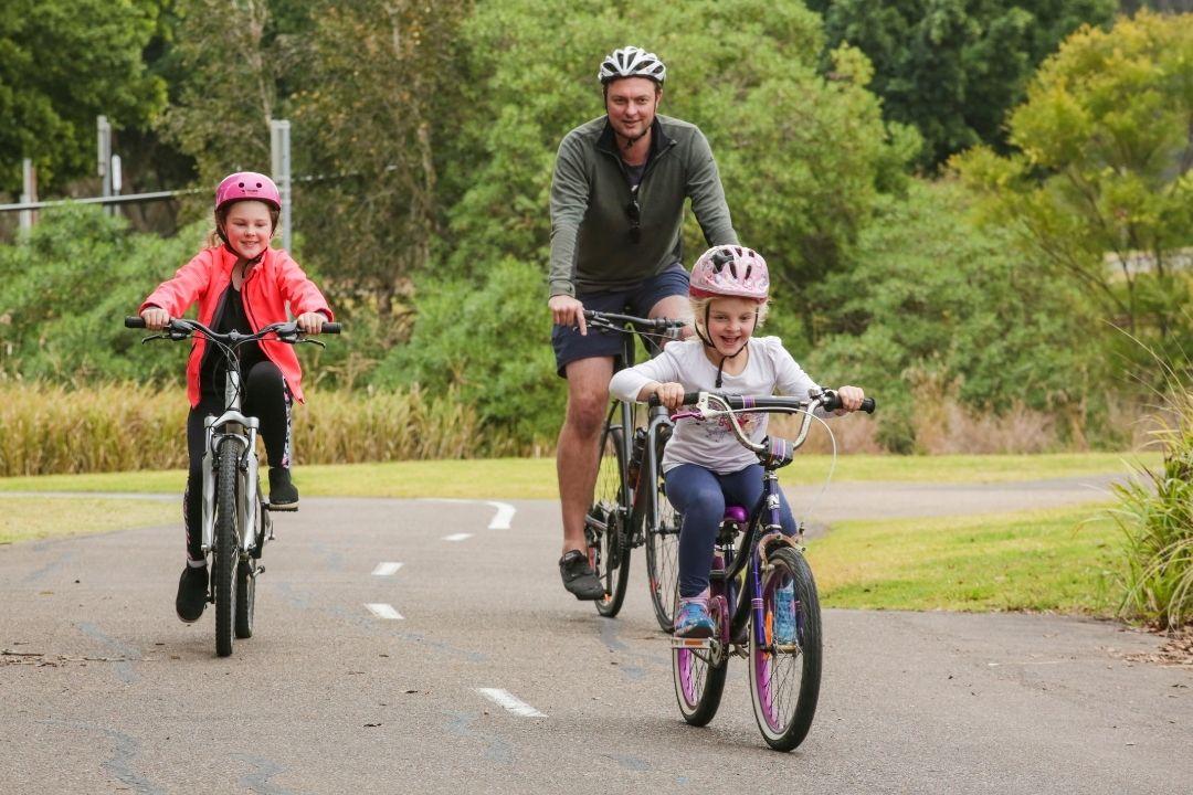 Father and daughter riding bikes