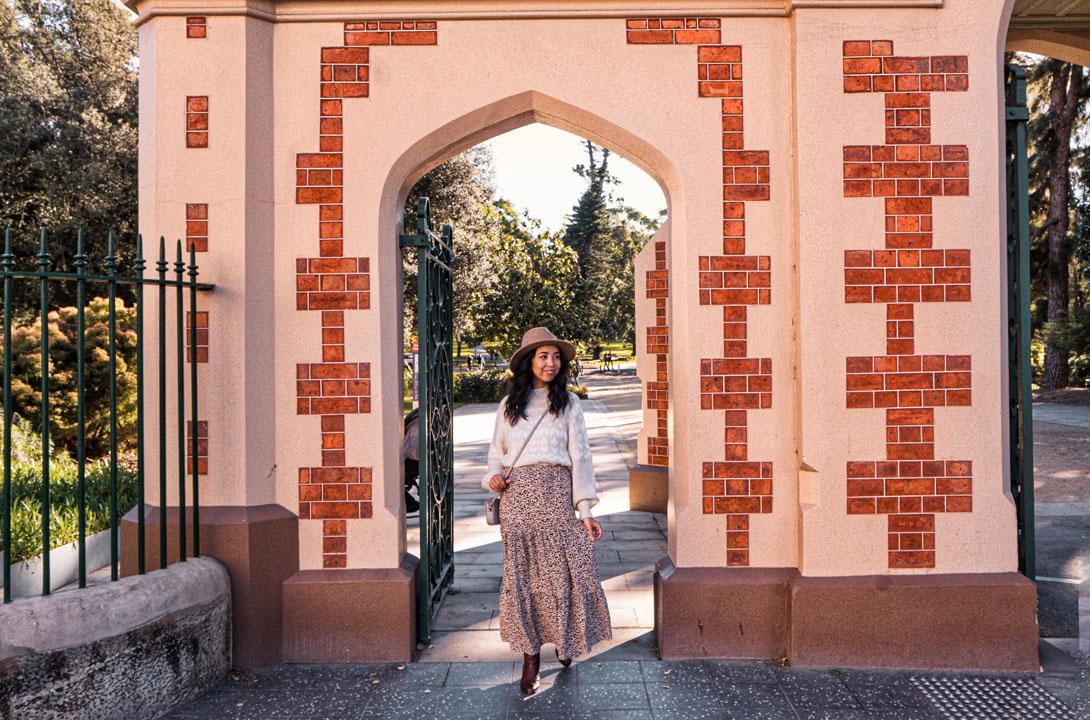 Woman wearing fashionable outfit standing outside George Street gatehouse