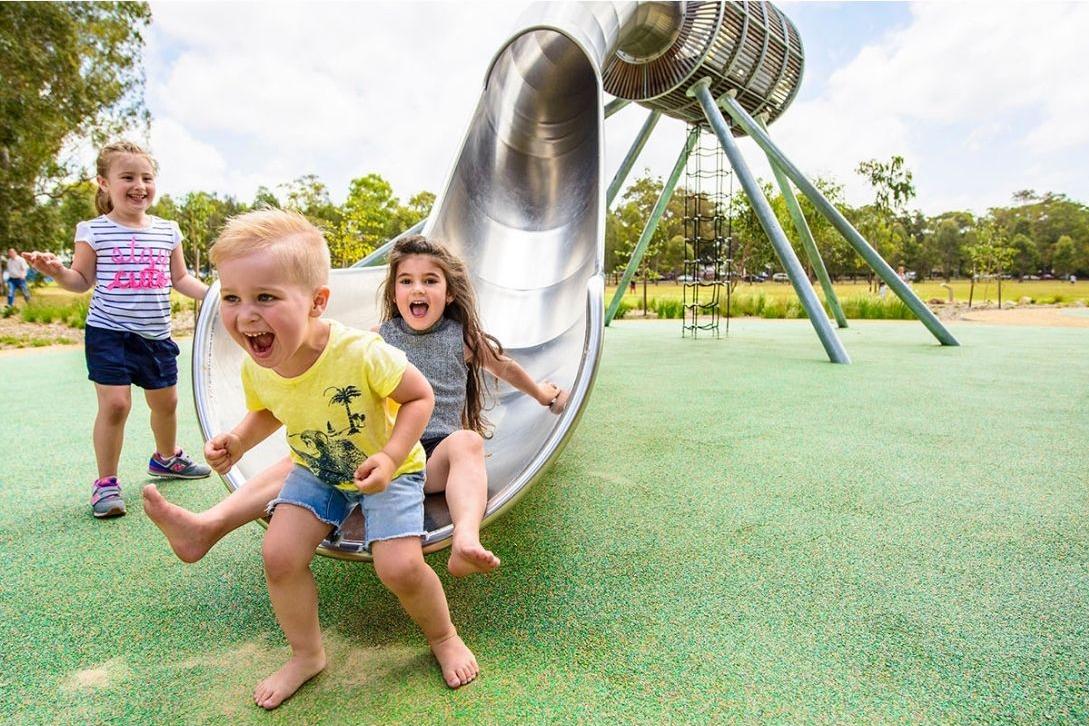 kids sliding down a slide