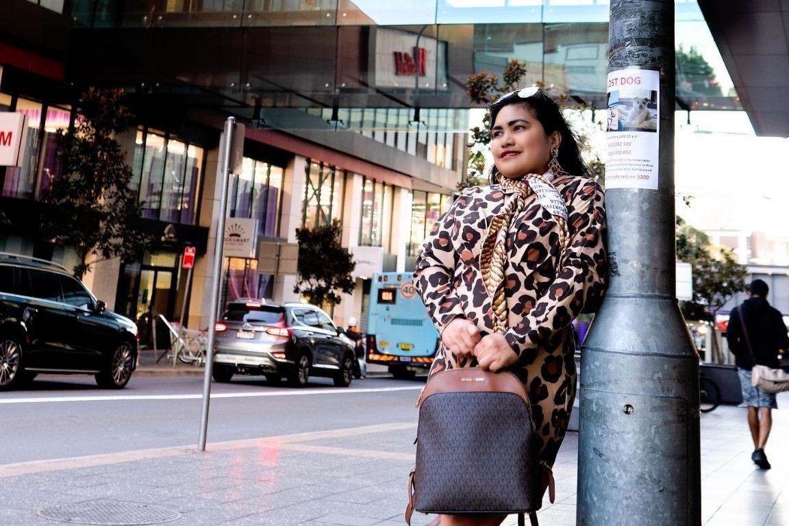 Woman holding handbag outside Westfield