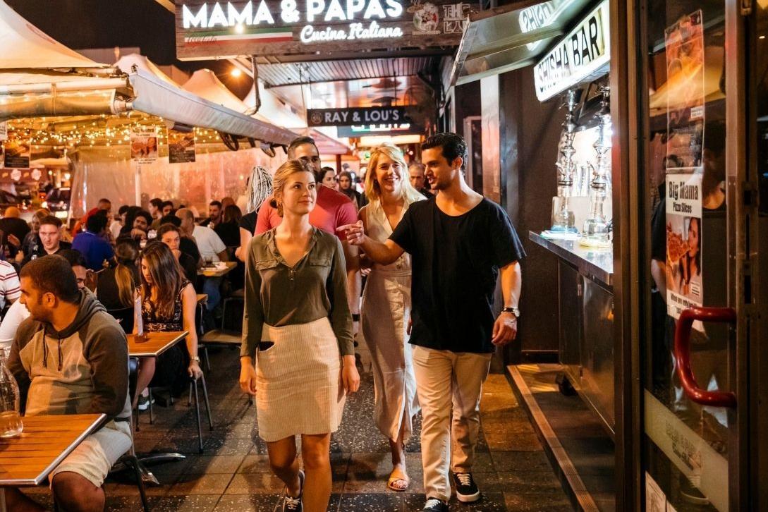 man walking through Eat St Parramatta