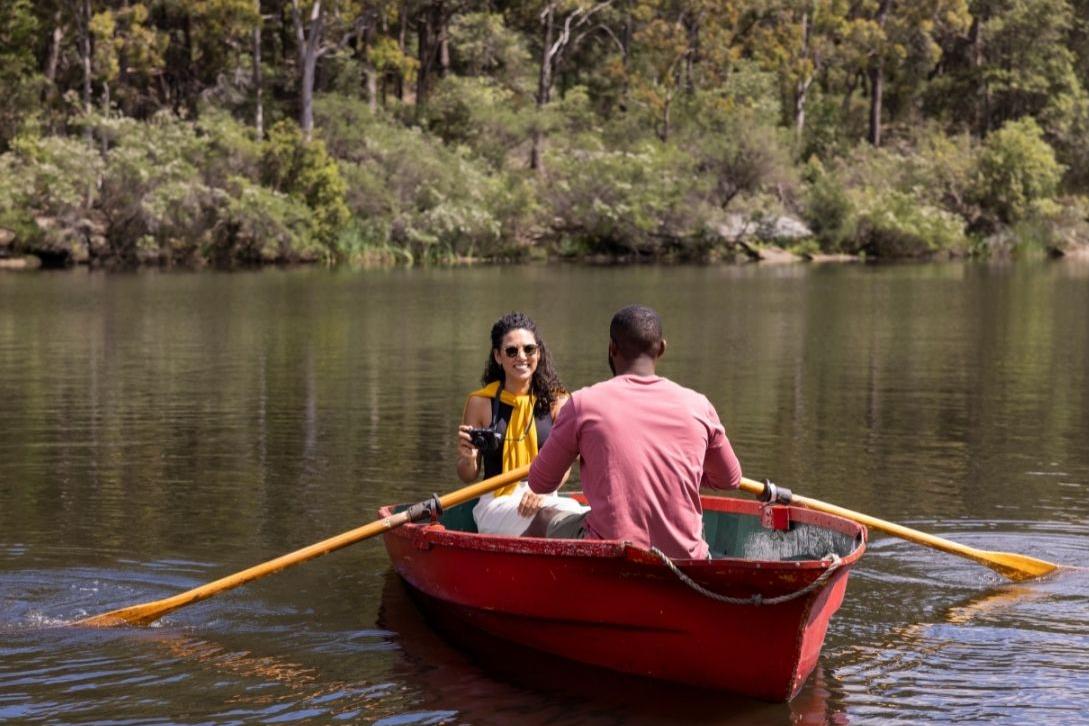 a couple in a rowing boat on lake parramatta