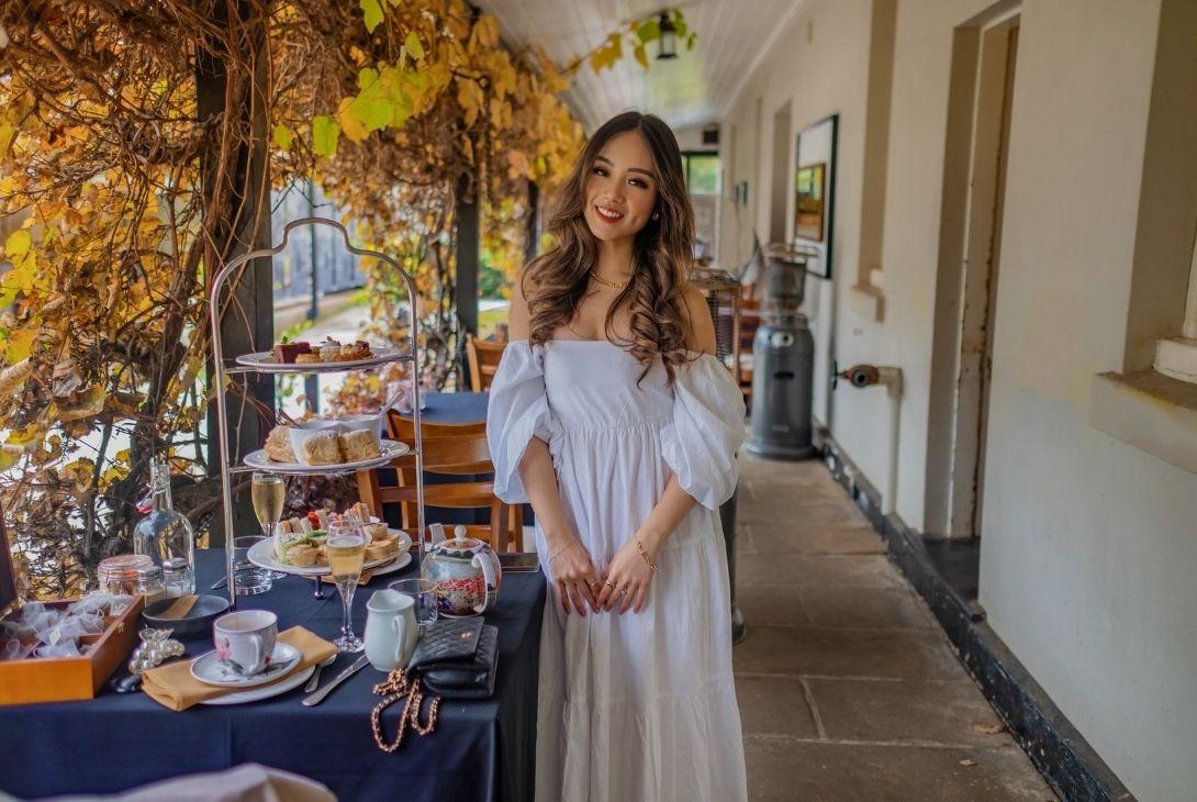 lady having high tea verandah Lachlans