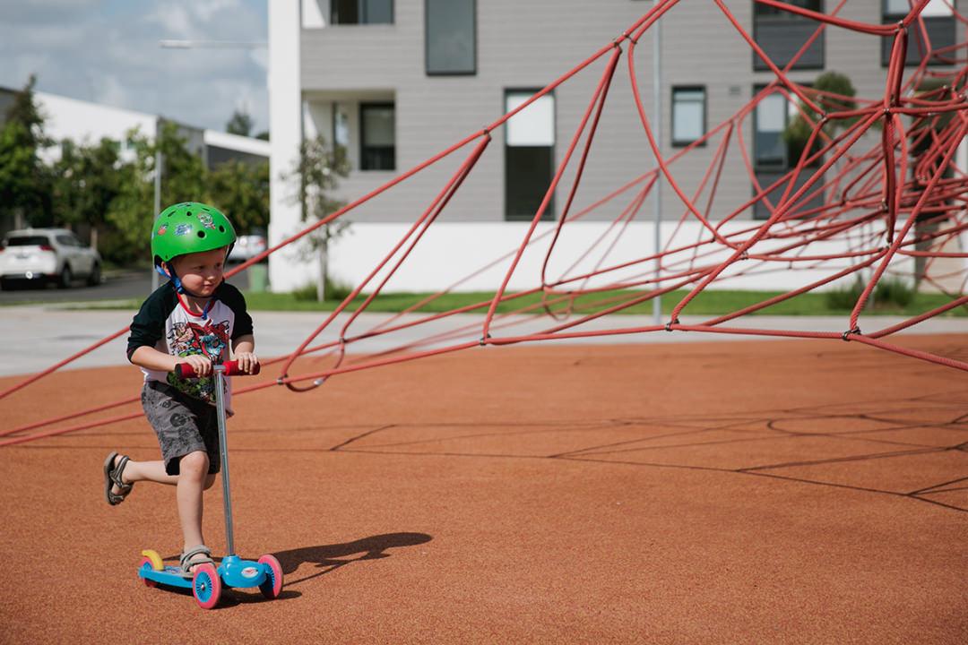 kid on scooter at park