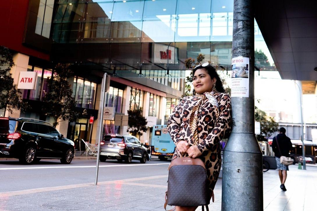 woman carrying handbag standing outside Westfield