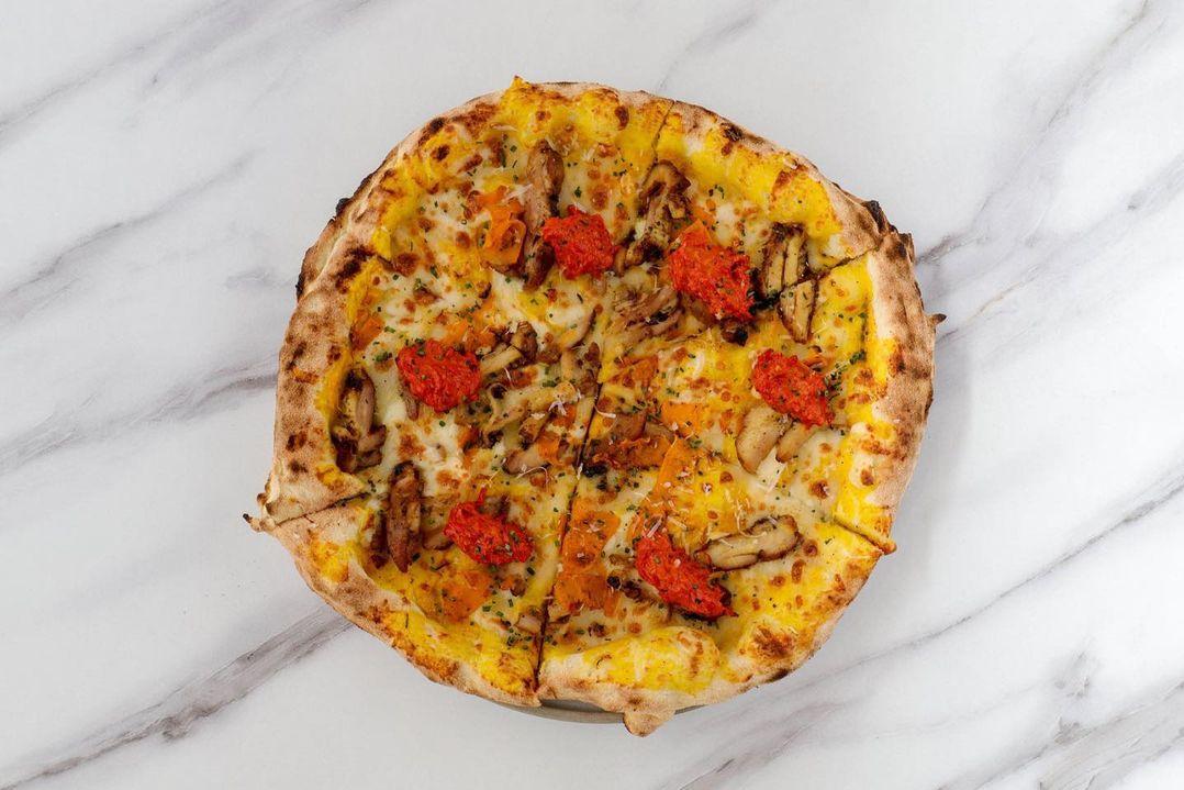 a pizza on a marble surface