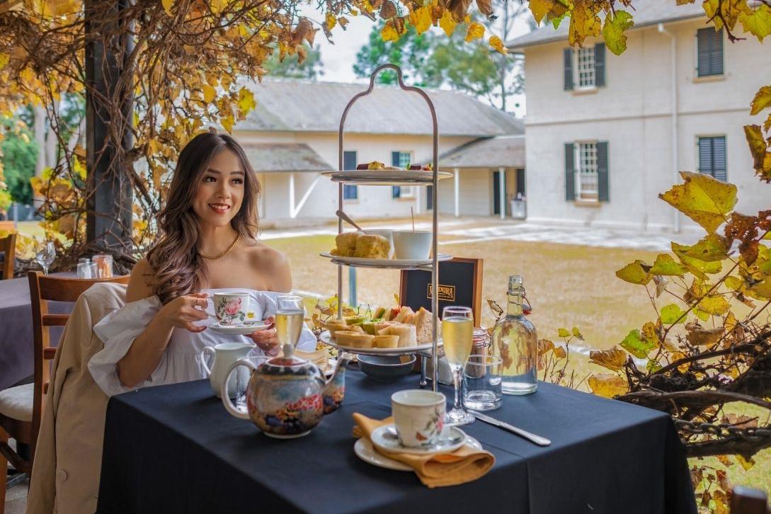 woman enjoying a high tea at lachlan's