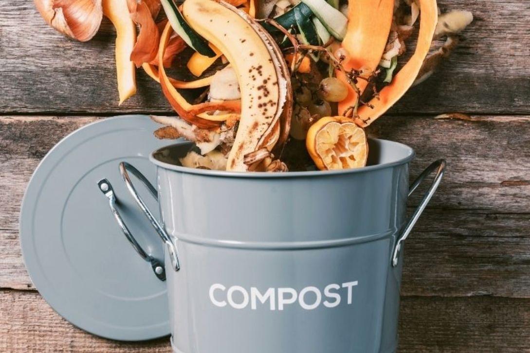 compost bin with food scraps pouring out of it