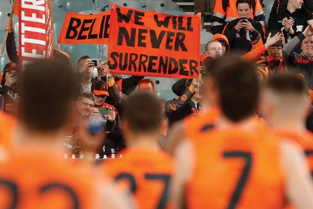 GWS GIANTS supporters in a crowd and GWS GIANTS players