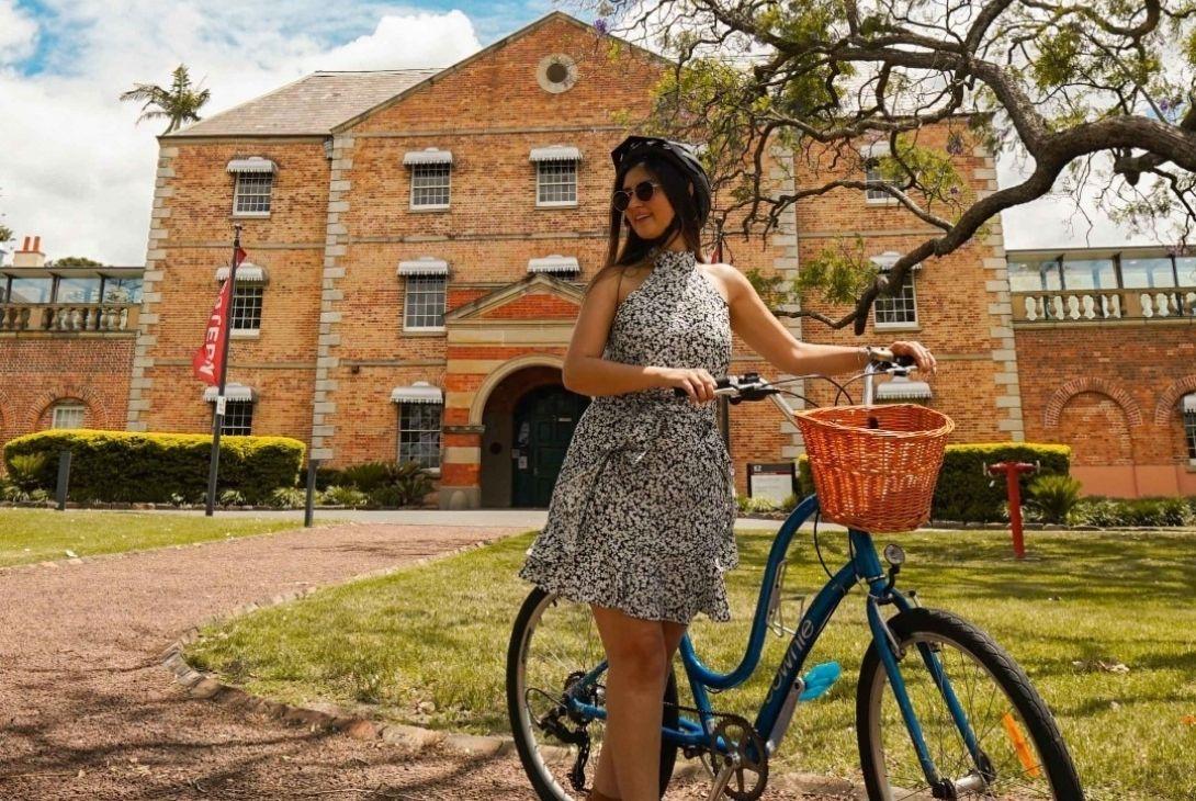 woman on bike in front of whitlam institute