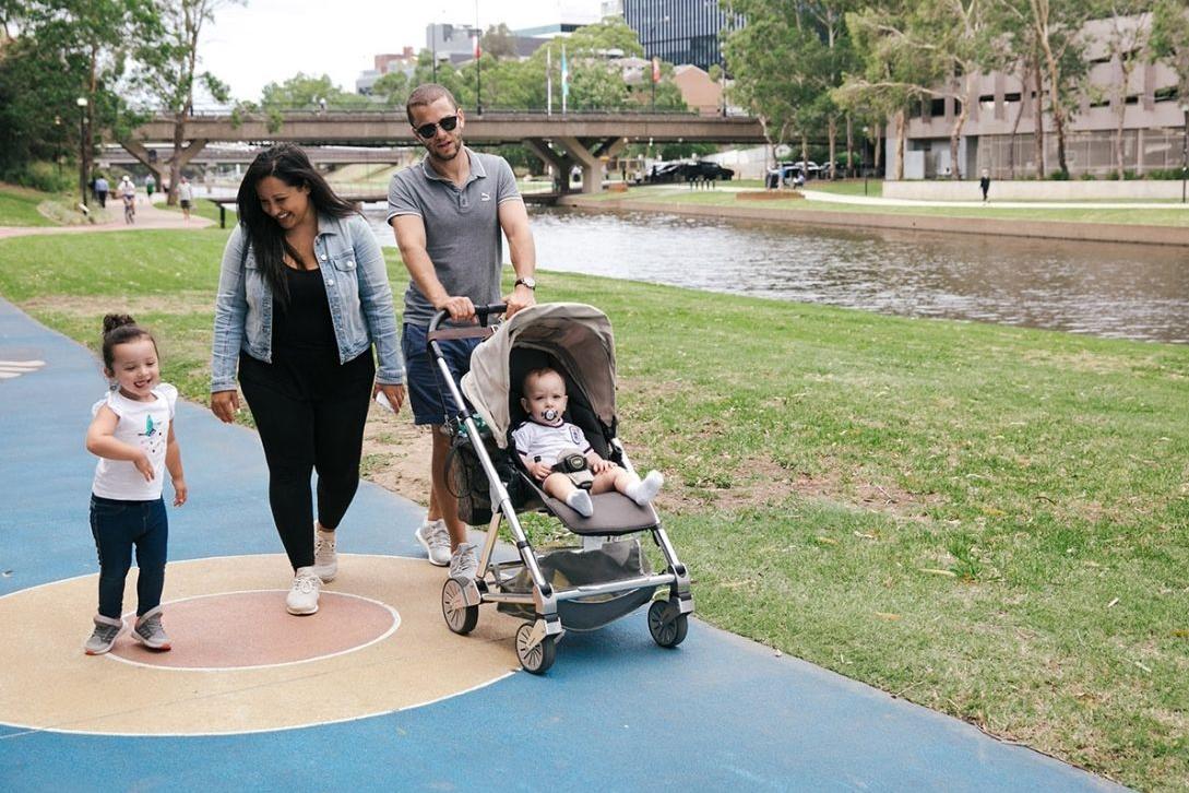 family walking along path next to parramatta river